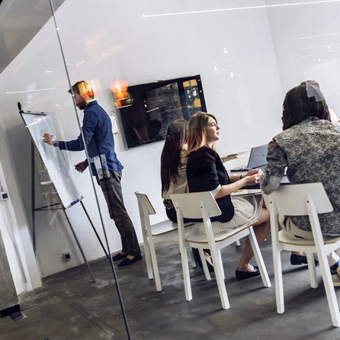 Group of coworkers at an office brainstorming and presentation