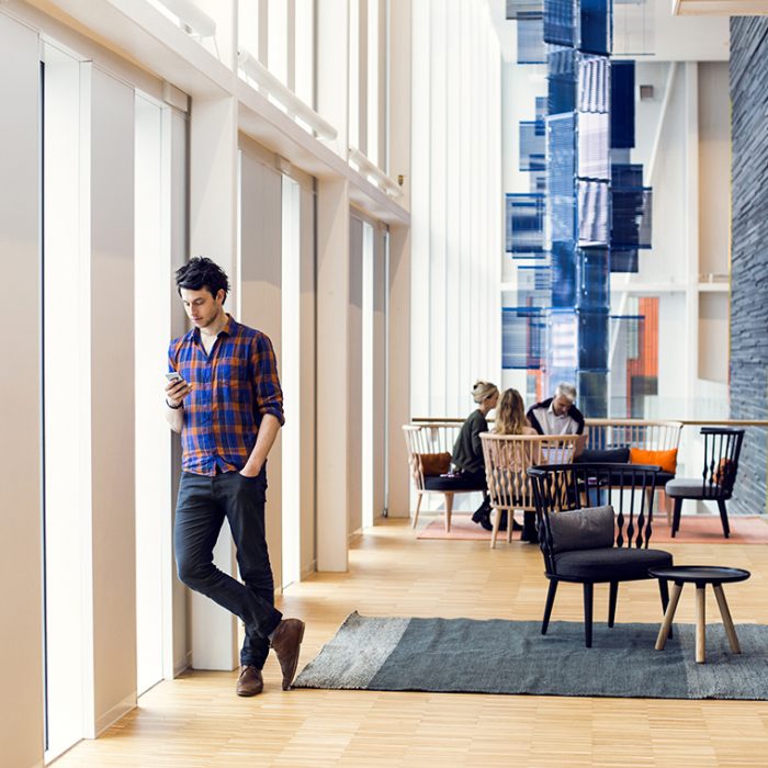 Businessman using smart phone at hotel lobby