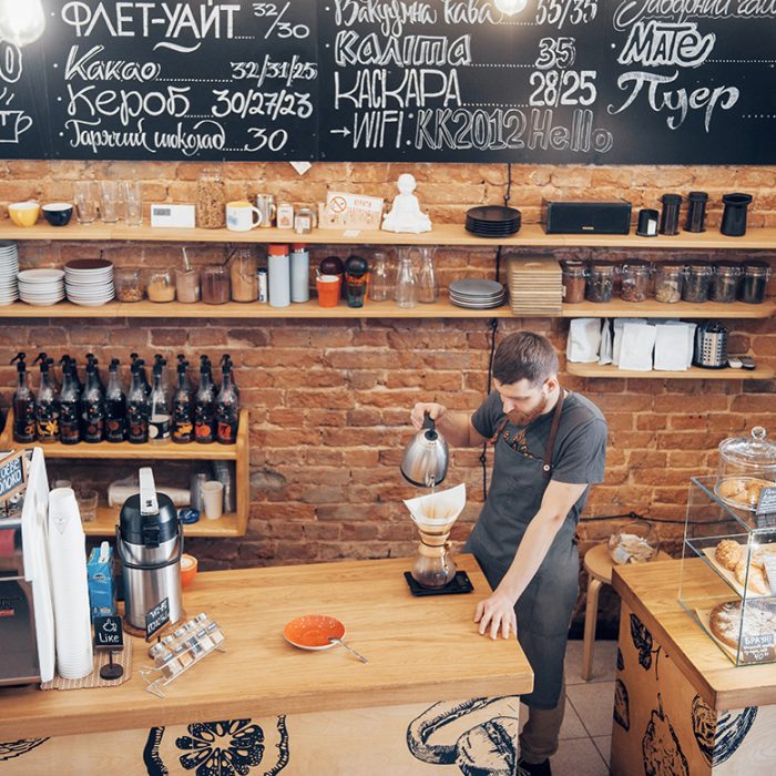 Coffee Shop Bar Counter Cafe Restaurant Relaxation Concept. Popular modern coffee shop busy with staff.