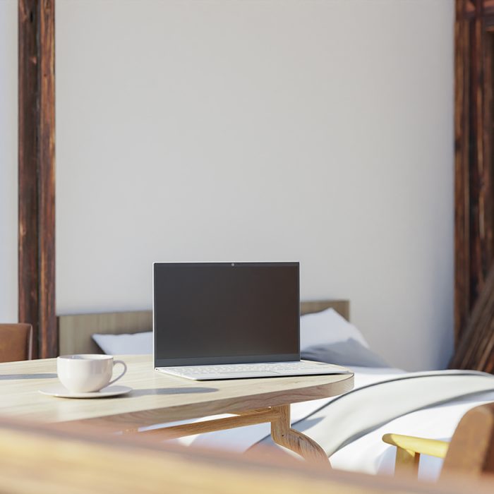 Office with furniture, work desk and laptop